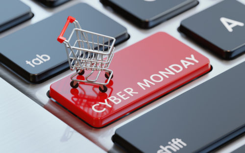 Modern computer keyboard with a shopping cart and a red Cyber Monday button. Horizontal composition with selective focus and copy space. Great use for shopping and Cyber Monday related concepts.