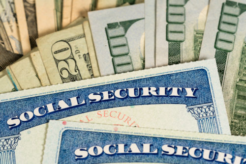 USA Social security cards laid on dollar bills